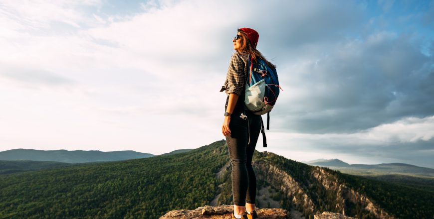 a-woman-meets-the-sunset-in-the-mountains-man-tra-2022-01-21-20-44-12-utc