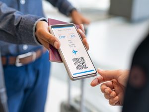 Man showing digital flight e-ticket to stewardess