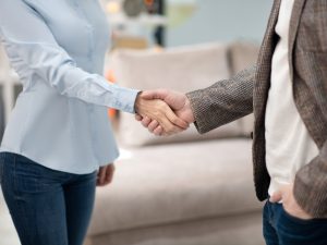 Manager in furniture shop meeting new customer