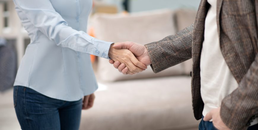 Manager in furniture shop meeting new customer